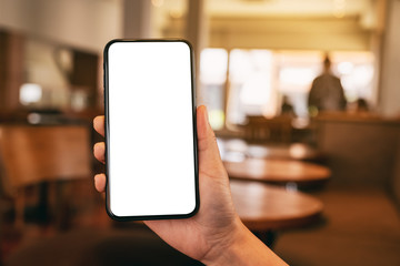 Mockup image of a woman's hand holding black mobile phone with blank desktop screen