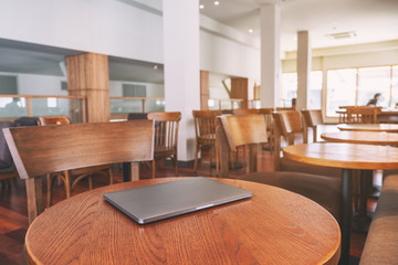 A single laptop computer on wooden table