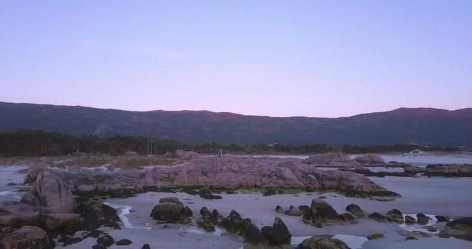 Sunset at a stunning Galician beach with a river estuary and a forest nearby n6