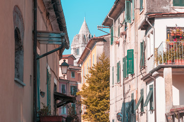 An alley with a view of the bell tower of the cathedral. Carrara, Tuscany. Italy.