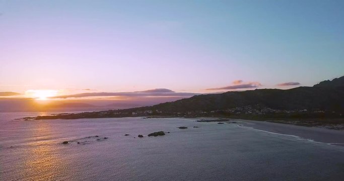 Sunset at a stunning Galician beach with a river estuary and a forest nearby n3
