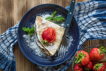 Polish pancakes with jam, cheese and strawberries.