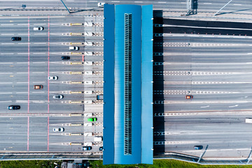 Toll roads on the broad highway. Through the point passes a large number of trucks and cars. Top...