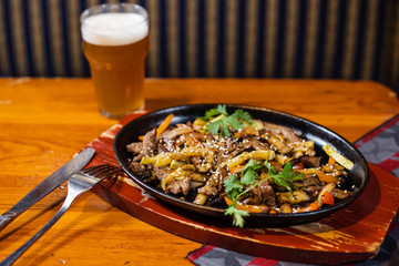 beef with vegetables finely chopped on the stove and light beer