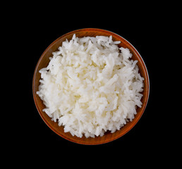 rice in wood bowl on black background