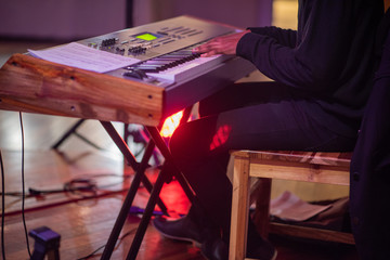 Artist playing keyboard during live music performance