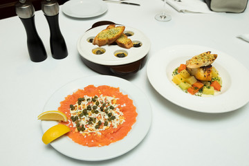 Salmon slice by fork knife with experience chef and arrange on fillet plate for roasted, sashimi,...