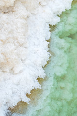 Fototapeta na wymiar Close up view of salt crystals and mineral formation on the shore of Dead Sea in Israel