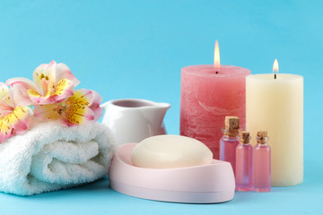 Obraz na płótnie Canvas Spa. Aromatherapy. Body care cosmetics. Handmade soap and aroma oil and sea salt on a gentle light blue background.