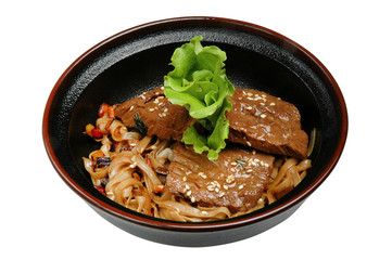 Noodles with mushrooms, lettuce and vegetables in a dark bowl on a white isolated background