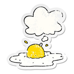 cartoon fried egg and thought bubble as a distressed worn sticker