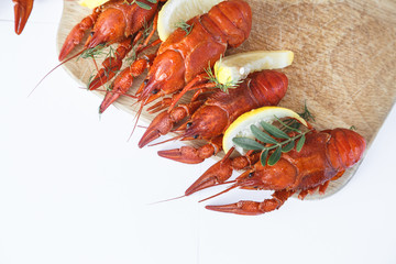 Close-up of boiled crayfish with lemon and herbs