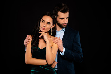 Close up photo rich pair classy she her chic hand arm fingers chin he him his hold shoulders look side piggyback pose wear blue plaid costume jacket velvet green dress isolated black background