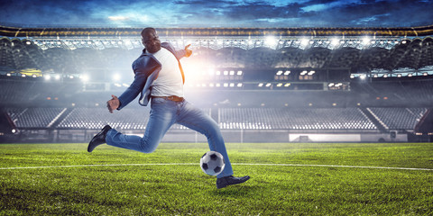 Obraz na płótnie Canvas Black man plays his best soccer match. Mixed media
