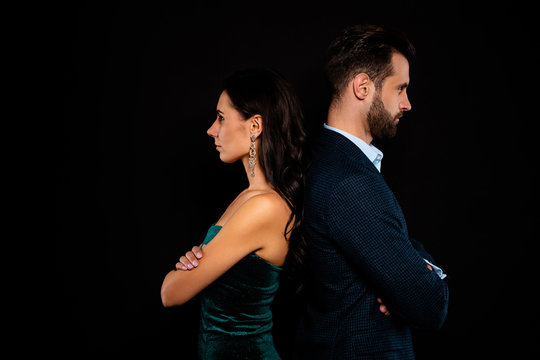 Close up side profile photo amazing pair she her classy he him his macho stand back to back confrontation arms crossed wear blue costume jacket green glossy velvet dress isolated black background