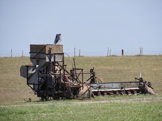Fototapeta na wymiar Vintage farm equipment in a farmland outside an 1880s village in South Dakota.