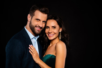 Close up side profile photo beautiful she her wife earrings he him his husband married spouse celebrities pop stars actors hands chest toothy wear costume jacket green dress isolated black background