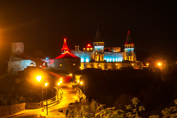 Fortress in Kamenetz-Podolsk at night in the light of lanterns
