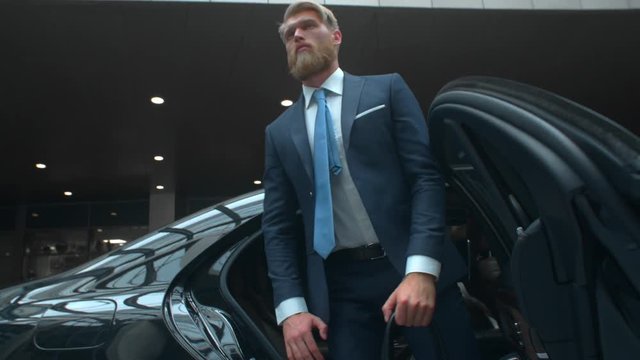 Businessman comes out of a executive car, top manager comes to the important meet, famous rich man comes out of his car with personal driver, business class car, Prores 422 HQ