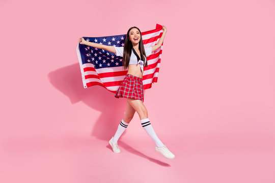 Full body profile photo of pretty lady carry usa flag college university english marsh wear white top short plaid skirt isolated pink background