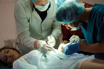 a group of surgeons doing operations in a hospital.