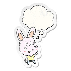cartoon rabbit and thought bubble as a distressed worn sticker