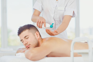 Fototapeta na wymiar Man getting massage in the spa salon. .