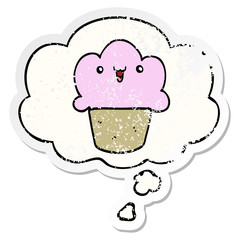 cartoon cupcake with face and thought bubble as a distressed worn sticker