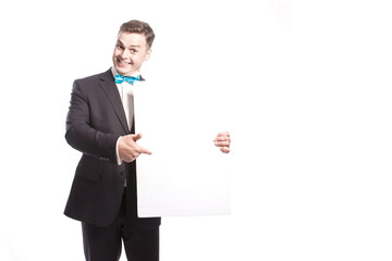 Funny man in a suit shows on a white sheet. On a white background in the studio.