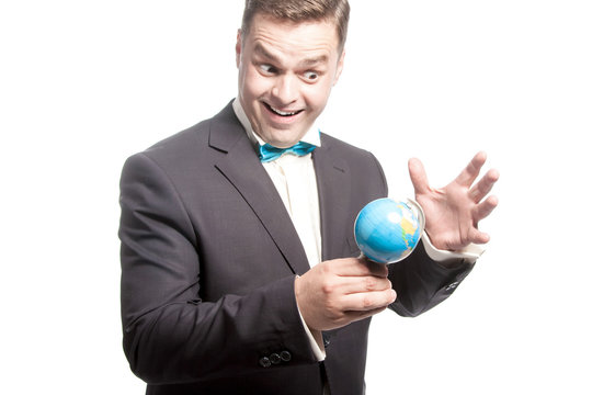 Funny man in blue bow tie holding little glode with crazy, weird face.