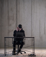 talented hacker using laptop computer while working in dark office