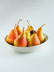 ripe yellow pears with drops in a plate