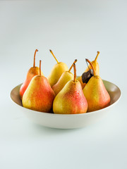 ripe yellow pears with drops in a plate