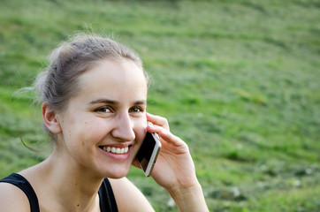 Girl talking on the phone and laughing. Photo.