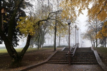 Naklejka na ściany i meble Autumn cityscape in the fog.