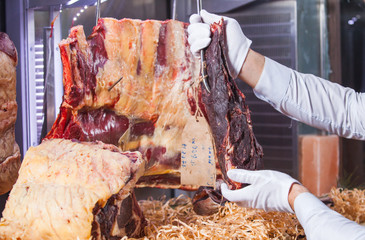 Display of Dry Aged Meat Steaks in butchers shop or restaurant in an display refrigerator.