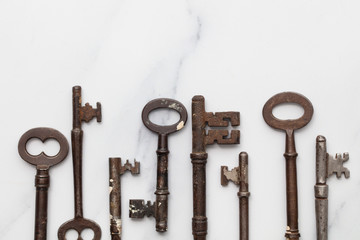 Vintage old fashioned keys on a marble background