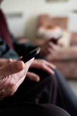old woman and old man using their smartphones