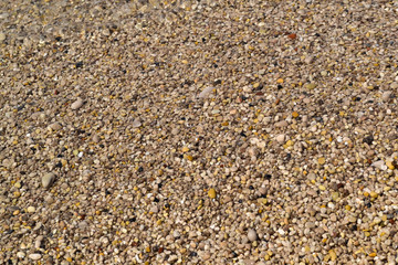 Sea foamy wave on a pebble beach top view
