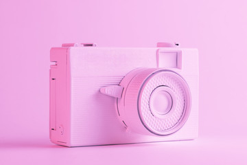Single painted camera against colored pink backdrop
