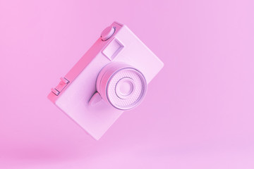 Tilt vintage camera against pink background