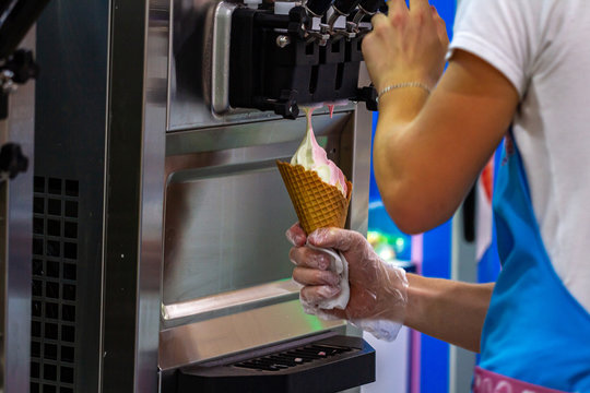 Preparation of creamy fruit ice cream from ice cream machine in shopping mall
