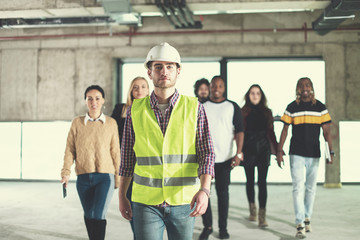 young multiethnic business people walking through unfinished startup office