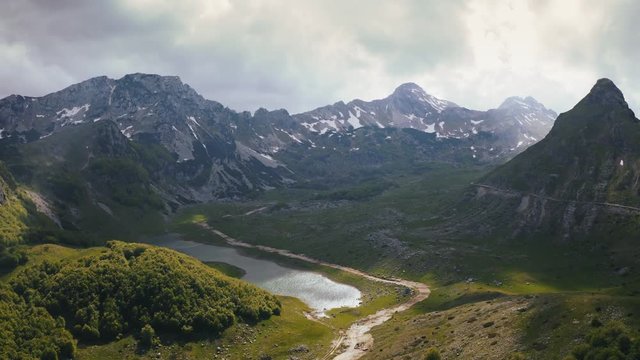 Cinematic aerial epic shot of mountains in national park Durmitor in Montenegro, clouds are moving fast