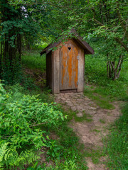 Old wooden restroom in a forest