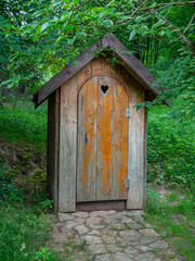 Old wooden restroom in a forest