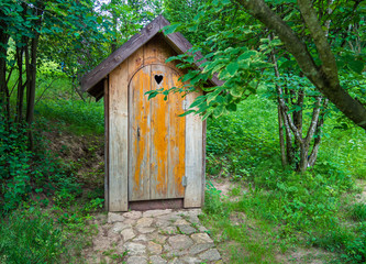 Fototapeta na wymiar Wooden shed ecological composting toilet on countryside eco farm - Concept image