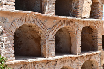 Old Spanish tombs in a sandstone wall.