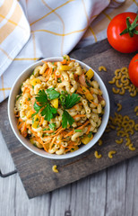 Pasta Salad with vegetable in a white bowl 