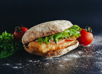 fried fish Sandwich with lettuce, tomato with tartar sauce. author's recipe street food